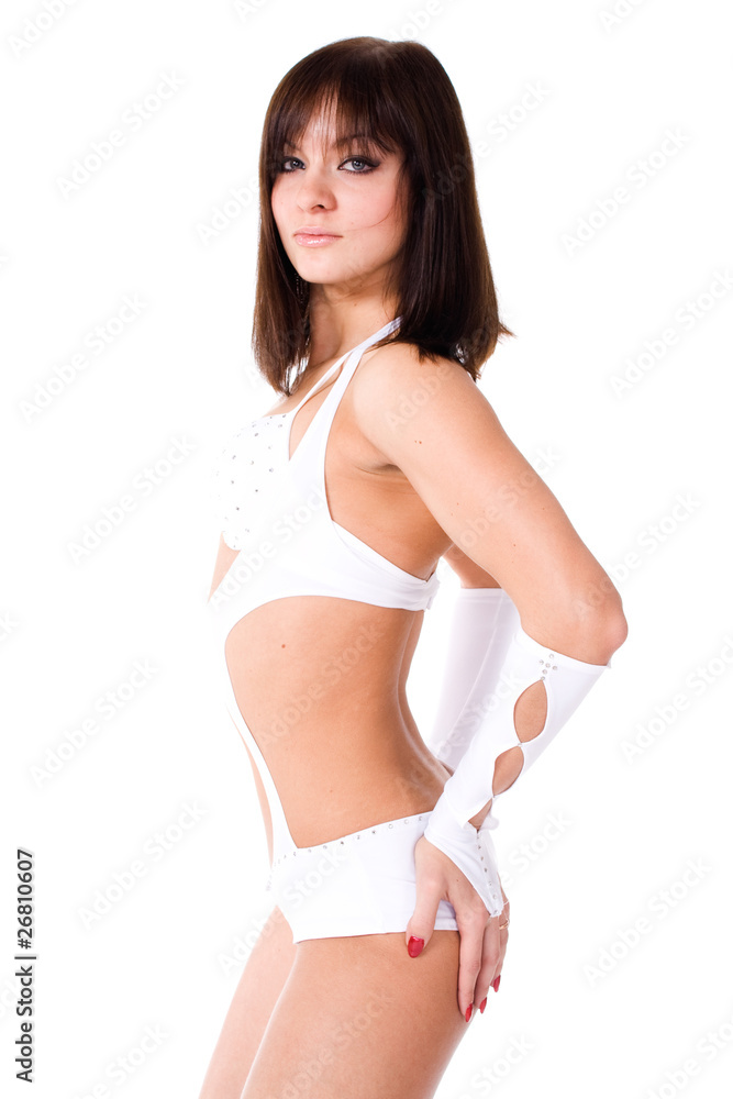 Fototapeta premium Sexy brunette in white bikini dancing on white background