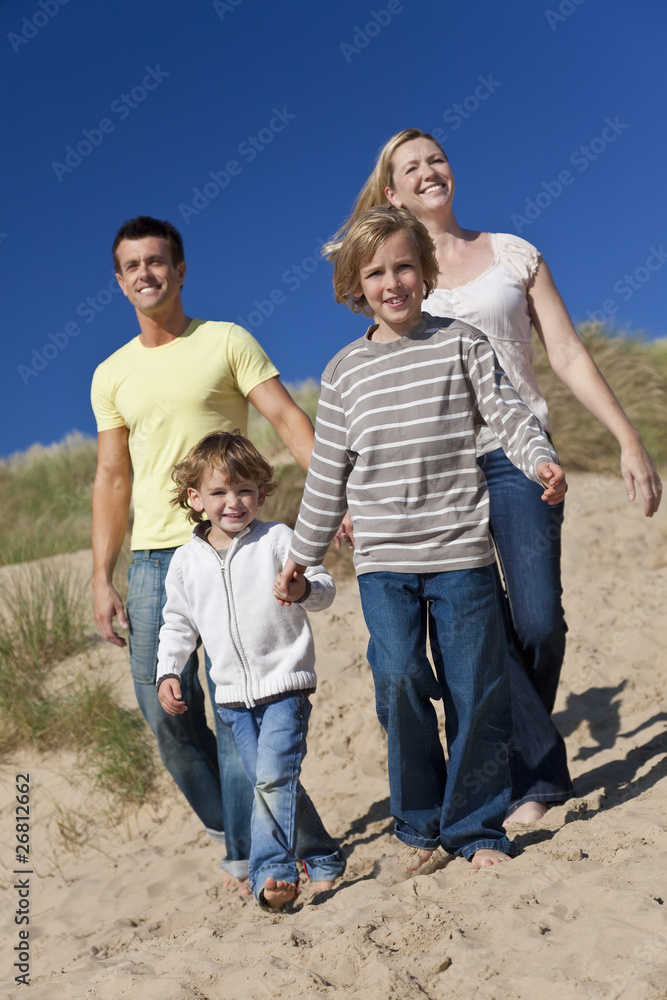 Mother, Father and Two Boys Walking Having Fun At Beach Mother, Father and Two Boys Walking Having Fun At Beach