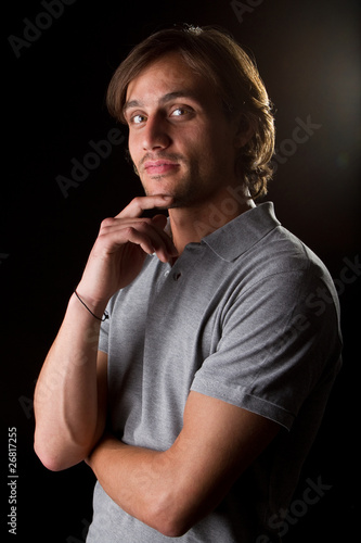 Young male model over black background