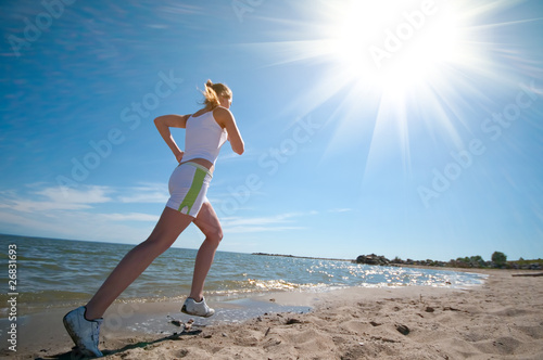 Sport woman running in sea coast