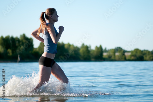 Sport woman running in water