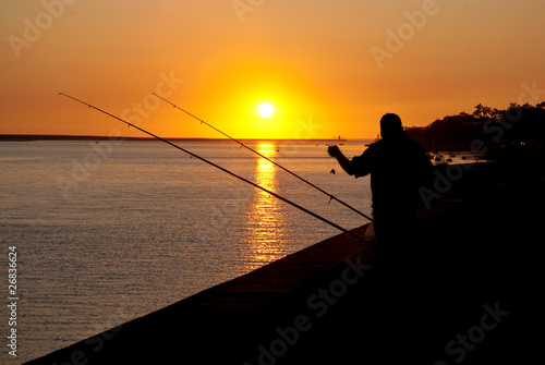 Man fishing on sunset