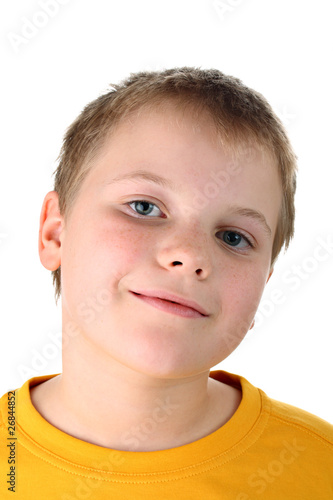 Smiling ten year old boy in yellow top isolated on white