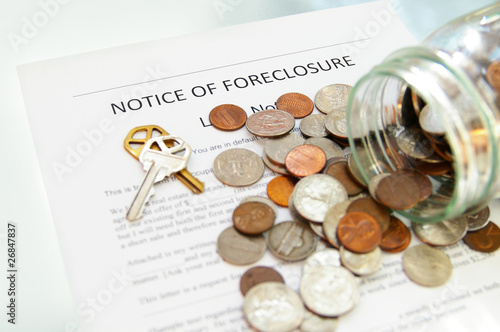bank foreclosure notice and spilled coin jar photo