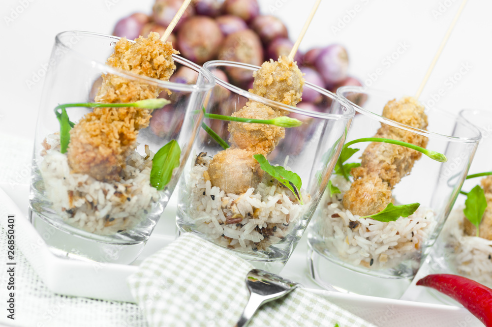 fried sausage balls with rice in a glass