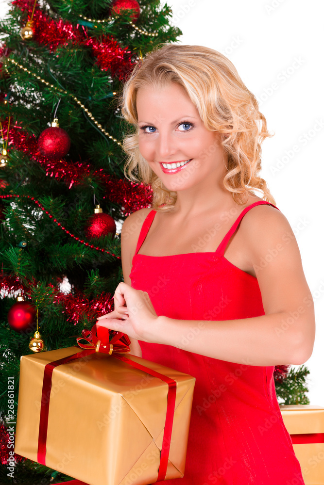 Young beautiful girl opening Christmas box Young beautiful girl opening Christmas box