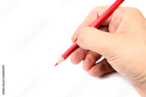Hand holding a red pencil on white background