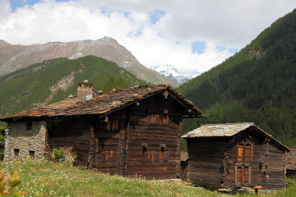 withered wooden houses in the mountains