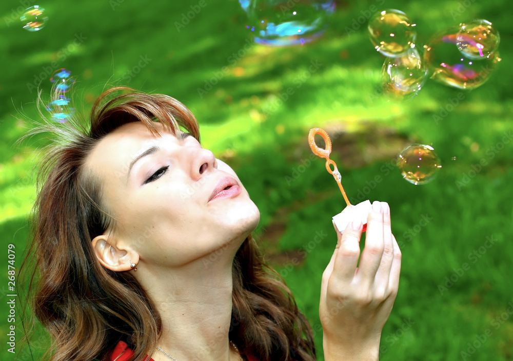 attractive girl blowing soap bubbles attractive girl blowing soap bubbles