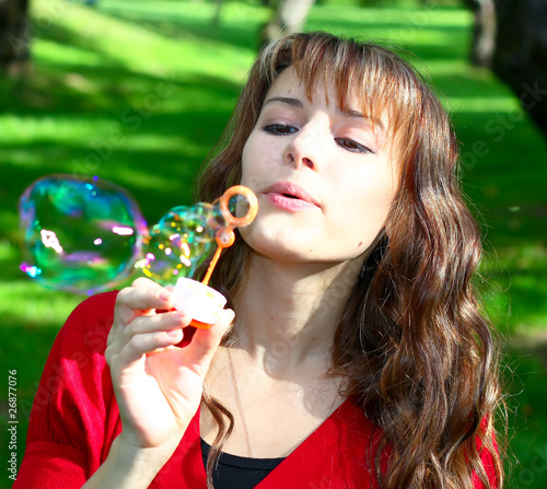 gorgeous girl blowing soap bubbles