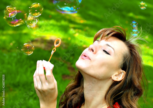 attractive girl blowing soap bubbles