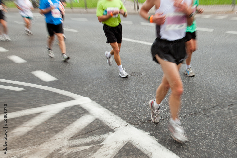 People running in marathon in intentional motion blur