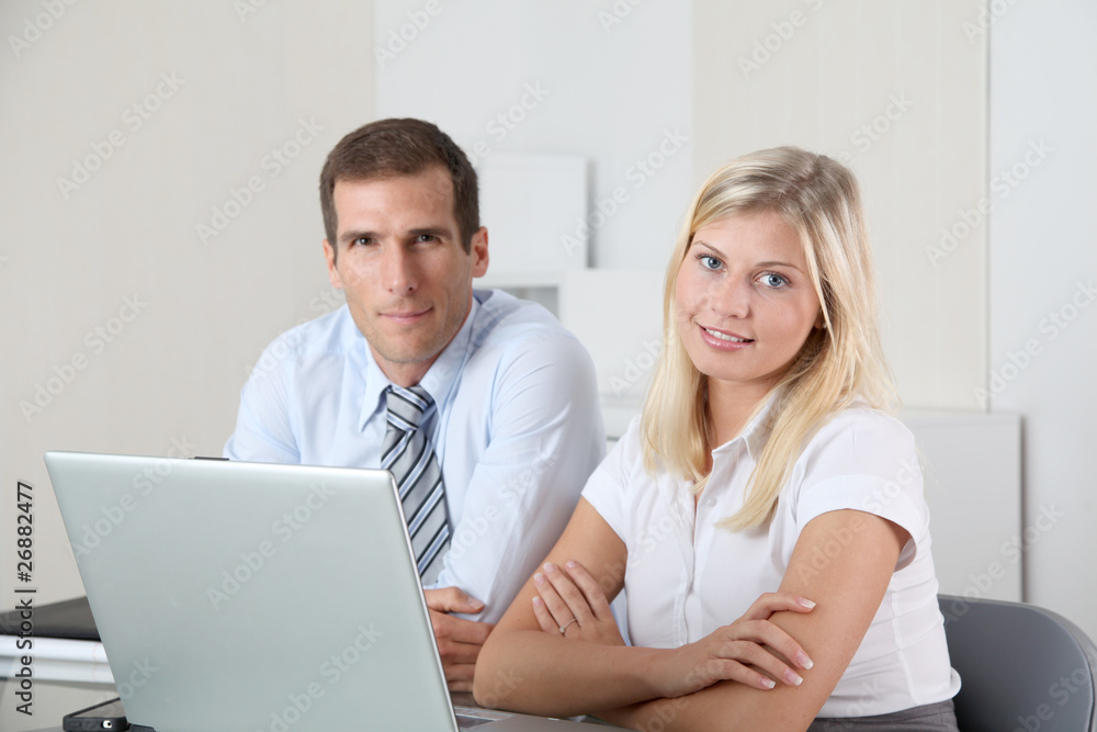 Man and woman working in the office on laptop computer Man and woman working in the office on laptop computer