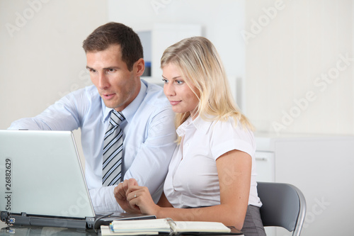 Man and woman working in the office on laptop computer © goodluz