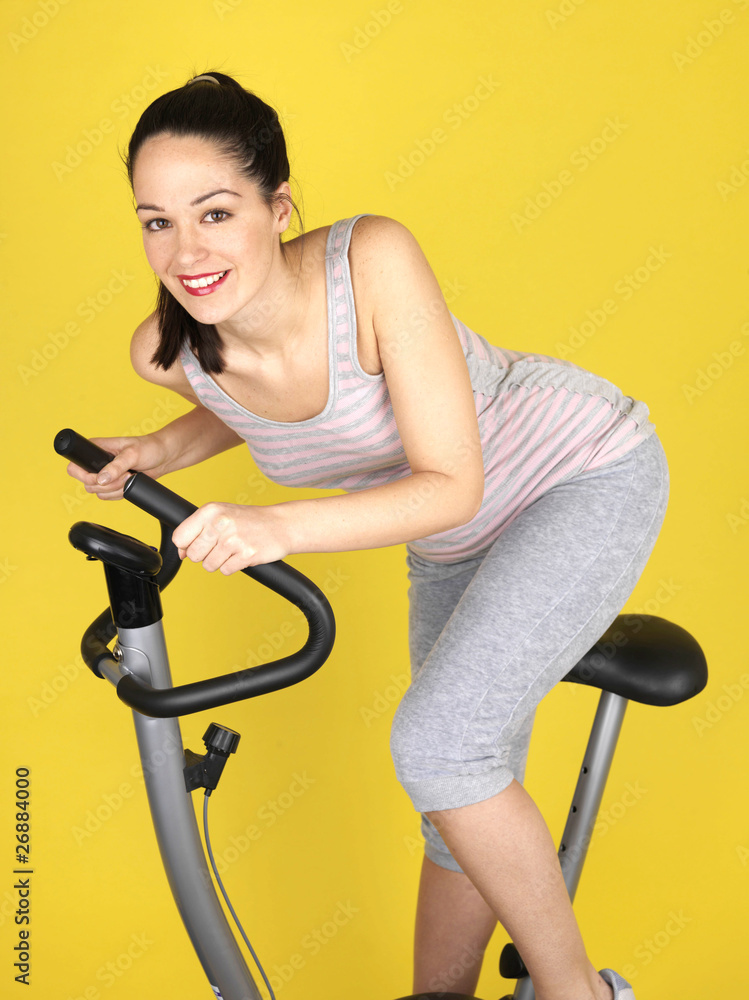 Young Woman Using Exercise Bike. Model Released Young Woman Using Exercise Bike. Model Released