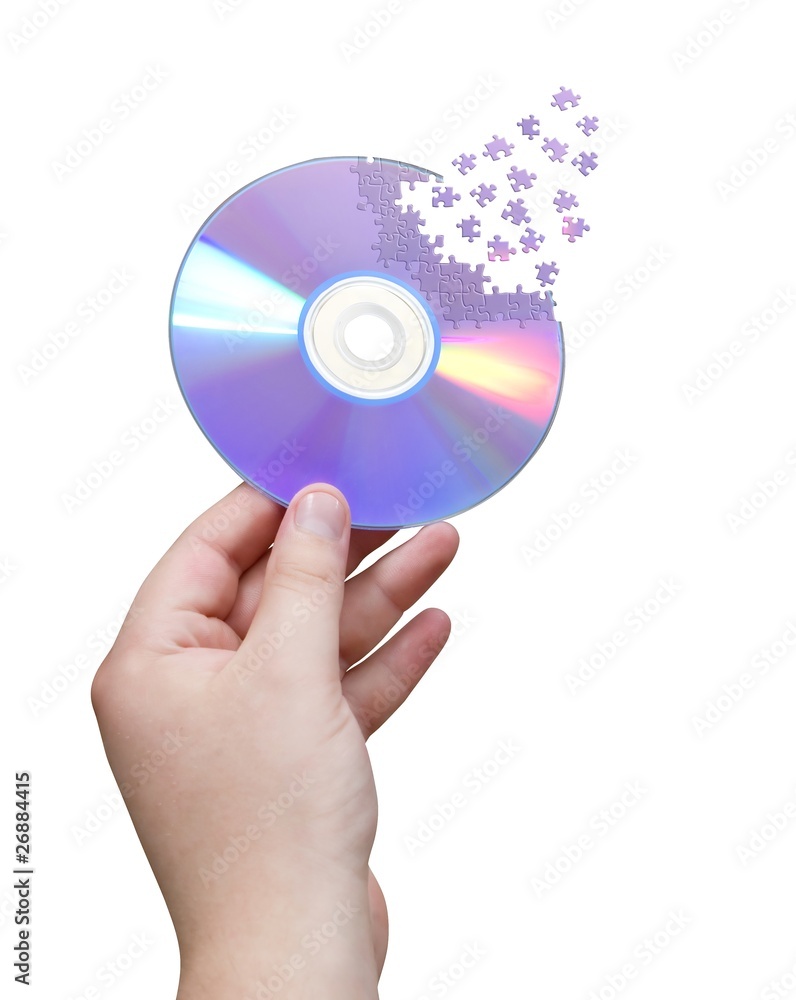 Cd in hand cut jigsaw puzzle isolated over white. Cd in hand cut jigsaw puzzle isolated over white.