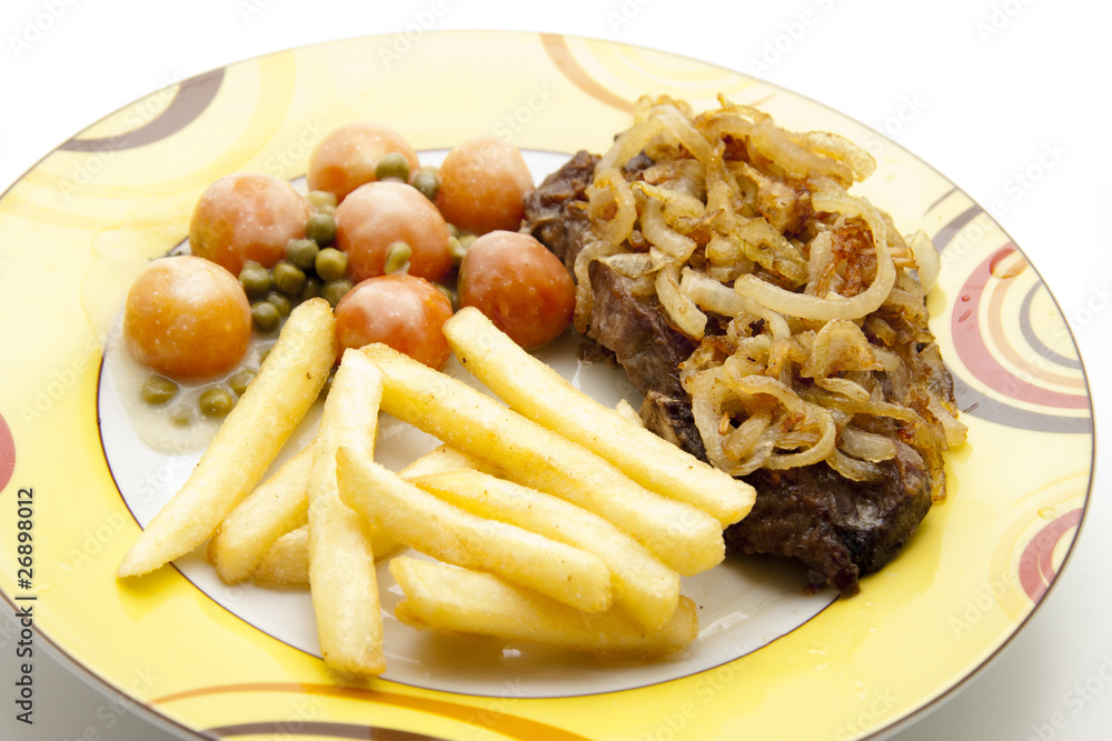 Kotelett mit Pommes Frites und Gemüse Kotelett mit Pommes Frites und Gemüse
