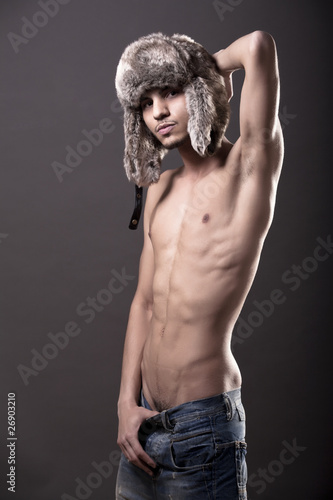 Half-naked gay guy posing in a busby photo