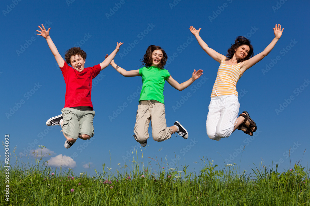 Active family - mother and kids jumping outdoor Active family - mother and kids jumping outdoor