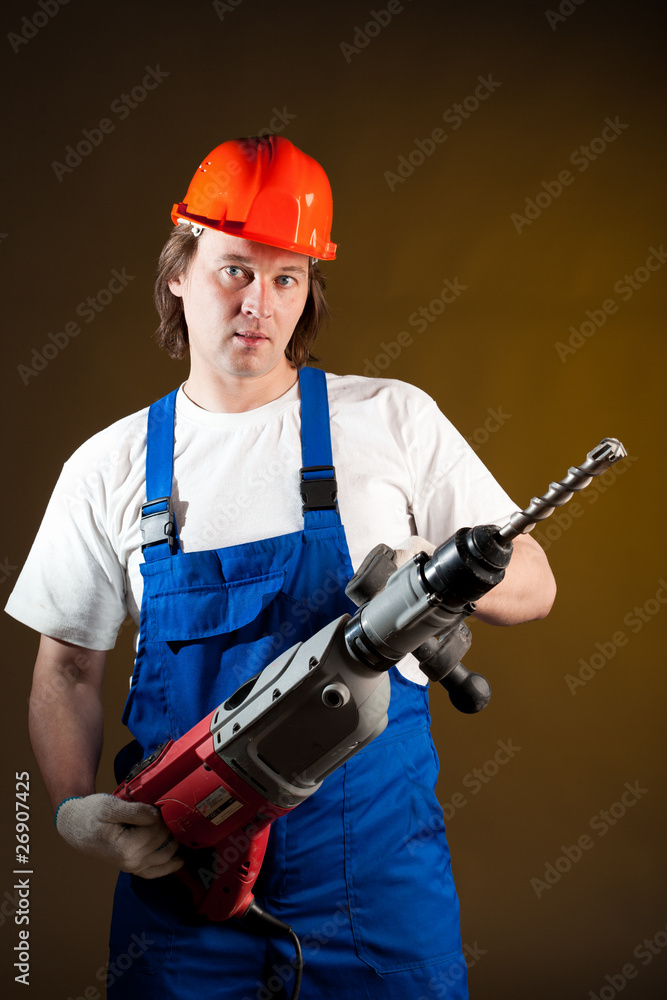 worker holding a machine drill worker holding a machine drill