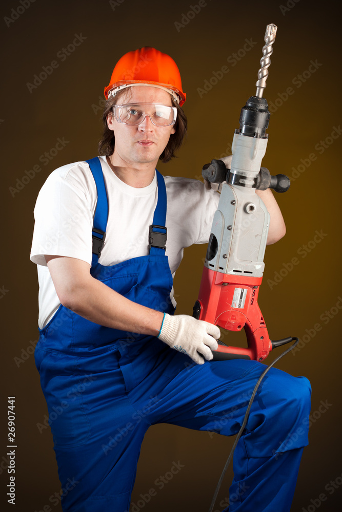 worker holding a machine drill worker holding a machine drill