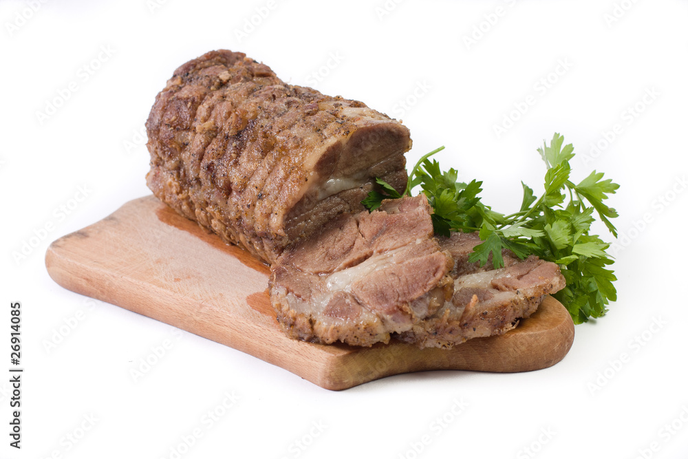 Appetizing piece of roasted meat on a wood piece with parsley Appetizing piece of roasted meat on a wood piece with parsley