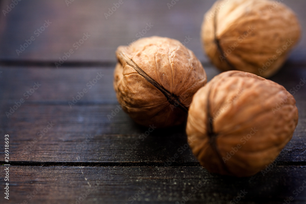 Walnuts on rustic wooden board