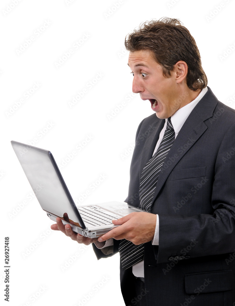 Young shocking businessman reading message on laptop Young shocking businessman reading message on laptop