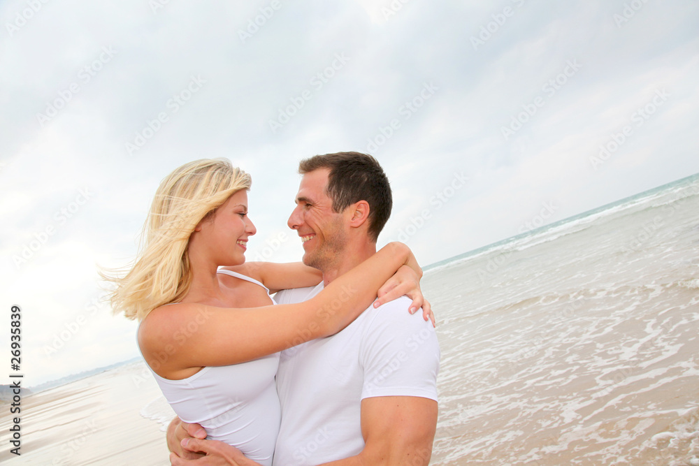 Happy couple enjoying vacation on a sandy beach Happy couple enjoying vacation on a sandy beach
