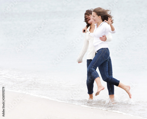 two young happy girl on beach