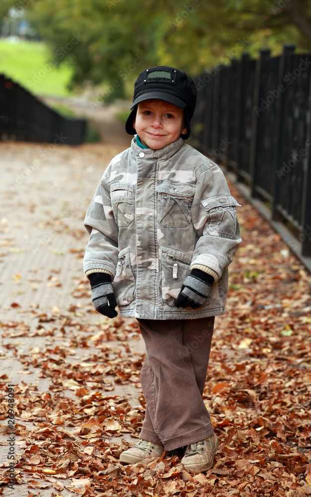 Little boy walking in autumn park Little boy walking in autumn park