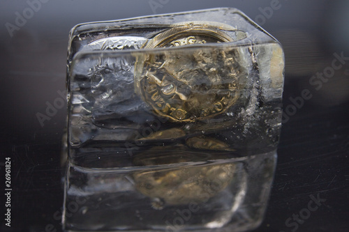 One pound coin in a block of ice