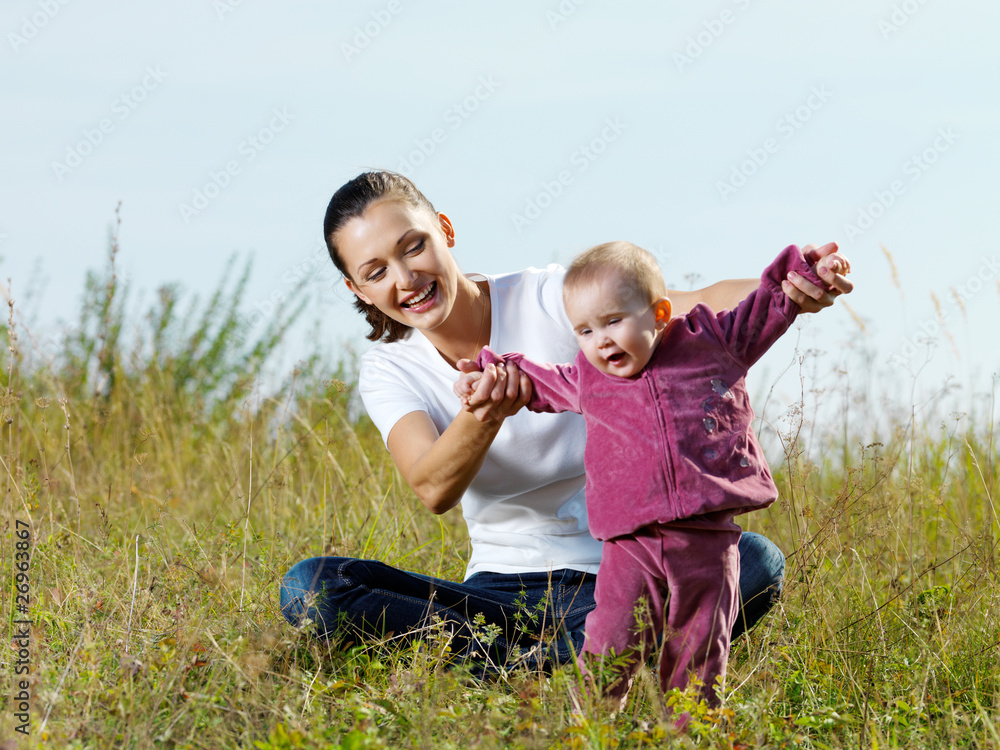 Fototapeta premium beautiful mather with smiling beby on nature