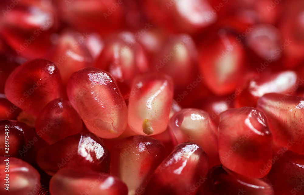 Pomegranate background. Macro of peeled ripe seeds Pomegranate background. Macro of peeled ripe seeds