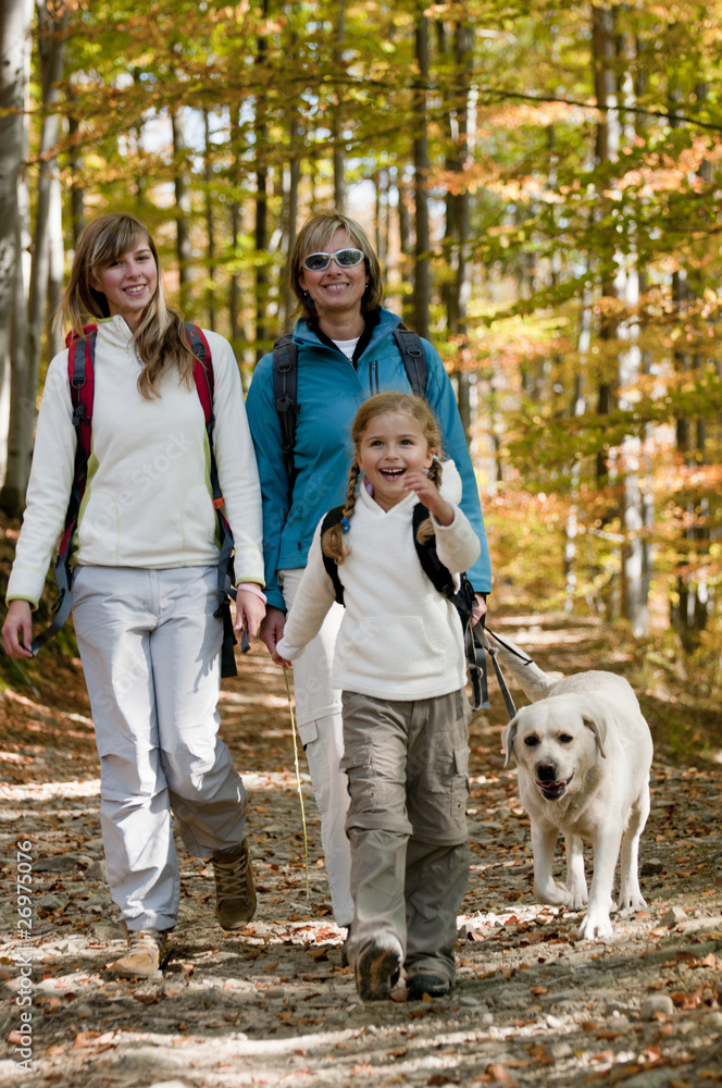 Family with dog on autumn trek Family with dog on autumn trek