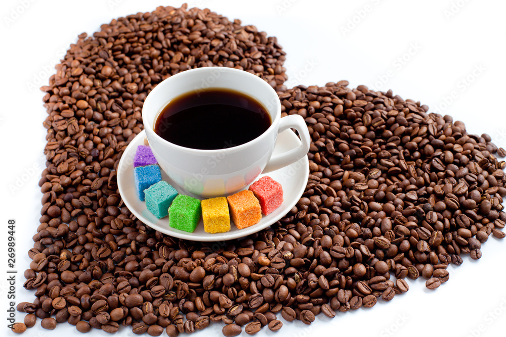 Coffee mug with rainbow colored sugar on beans in form of heart Coffee mug with rainbow colored sugar on beans in form of heart