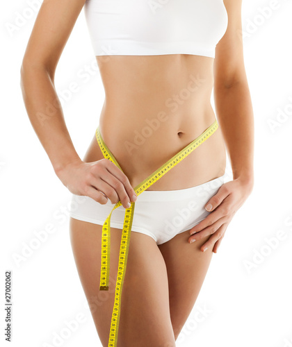 Woman measuring her slim body isolated on white