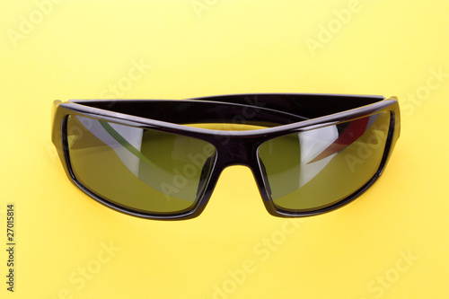 Sunglasses over yellow