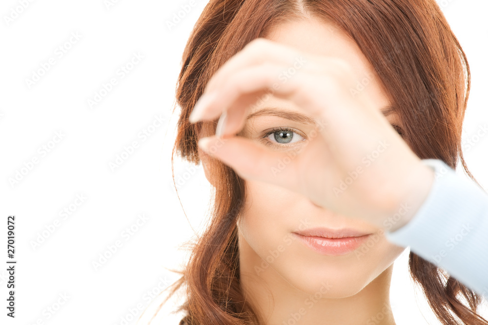 lovely woman looking through hole from fingers lovely woman looking through hole from fingers