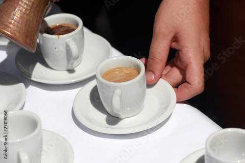 Waiter arranges coffee