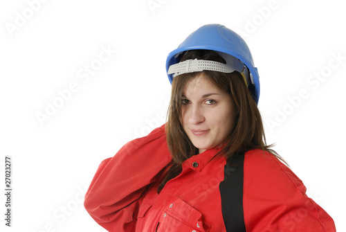 young female manual worker in coveral and helmet