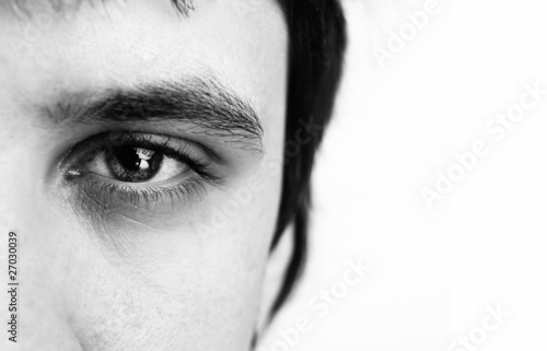 Macro shot of man's eye with visible blood vessels photo