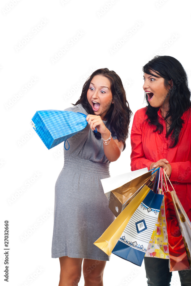 Two women friends having fun with a bag