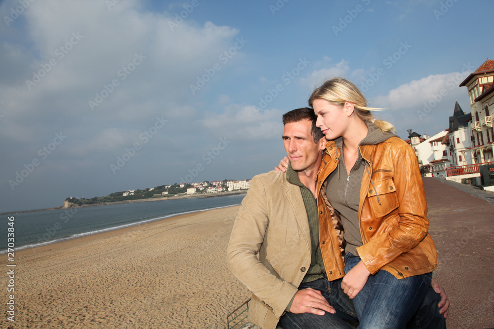 Lovers at the beach in autumn