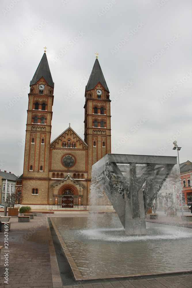 Roman catholic church and fountain on an area before him.