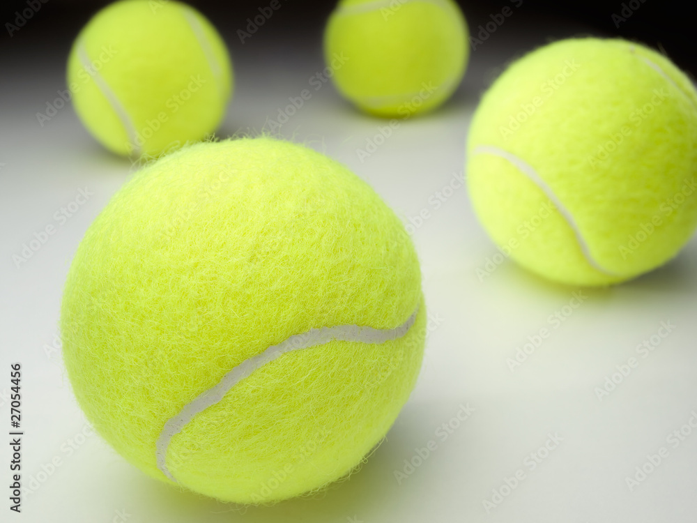tennis balls on  white surface