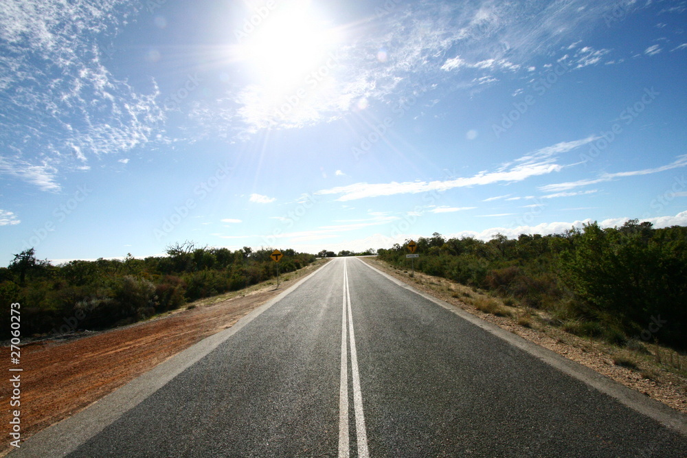 Road ahead with bright spot of sunshine Road ahead with bright spot of sunshine