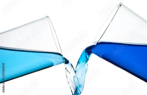 Two glasses spilling water or a similar blue liquid isolated on photo