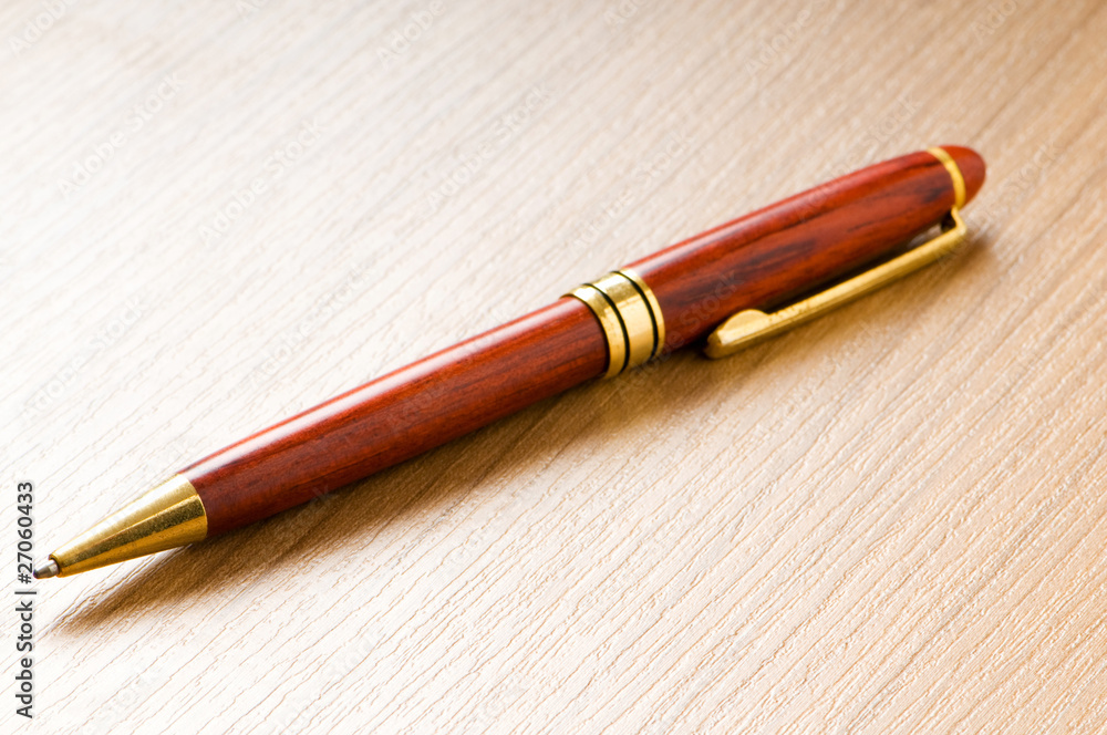 Writing silver pen on the wooden background Writing silver pen on the wooden background
