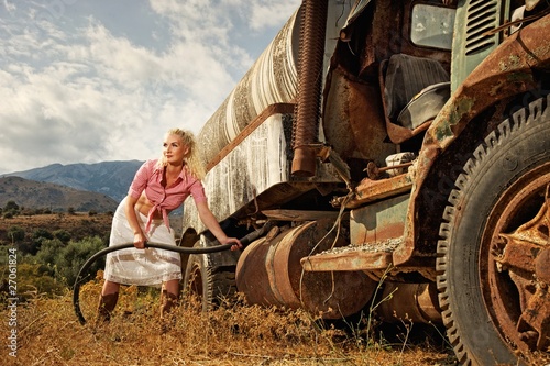 Attractive blond woman filling gas tank of an the old truck © Nejron Photo